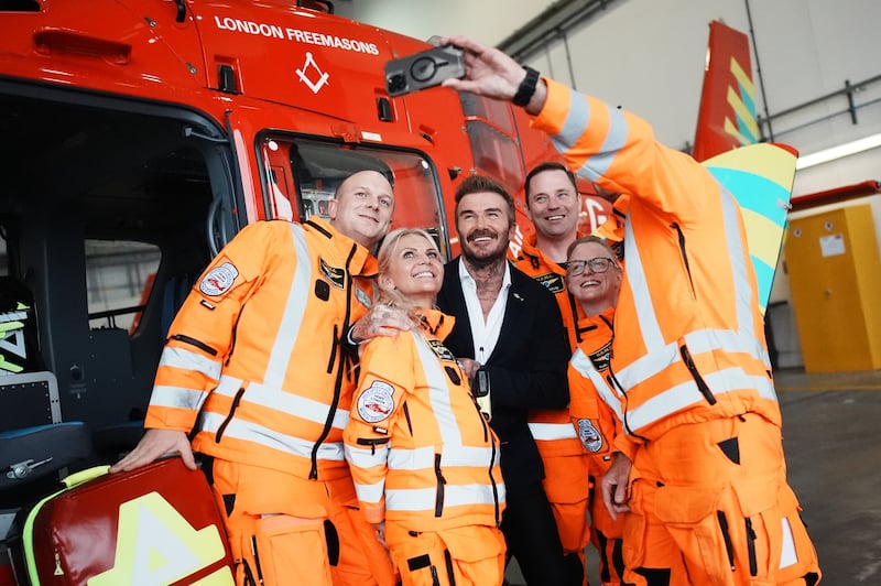 David Beckham poses for a selfie with members of the Air Ambulance crew during the visit