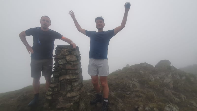 Jack Stacy (left) and Michael Smith (right) celebrate reaching the top of Scafell Pike, England’s highest peak during their 24 peaks in 24 hours challenge (SeeAbility)