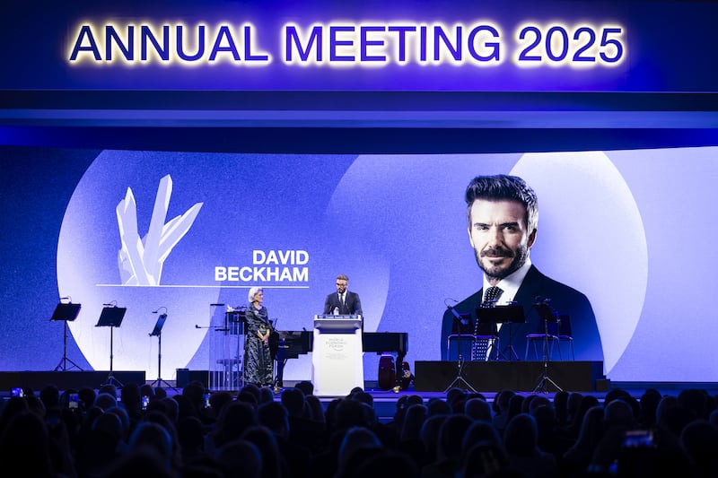 David Beckham speaks next to Hilde Schwab (Michael Buholzer/Keystone via AP)