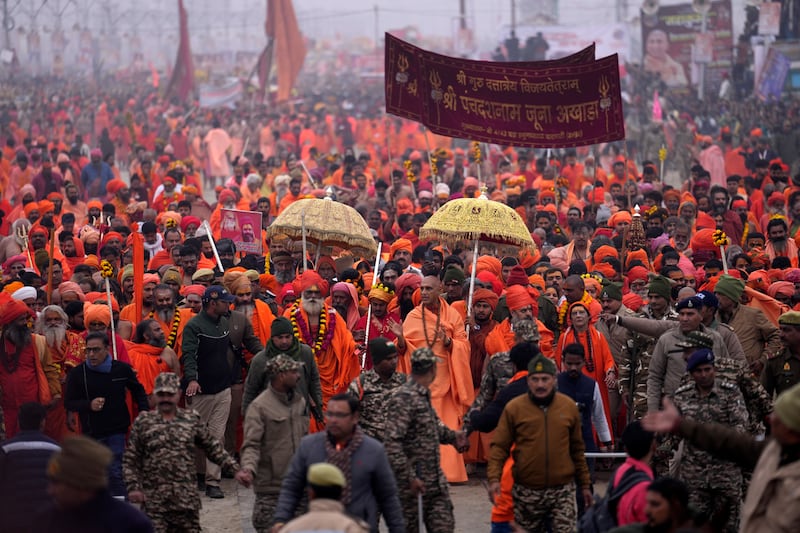 Hindu ascetics arrive for a ritualistic dip at the confluence of the Rivers Ganges, Yamuna and mythical Saraswati during the Maha Kumbh festival in Prayagraj, India (Rajesh Kumar Singh/AP)