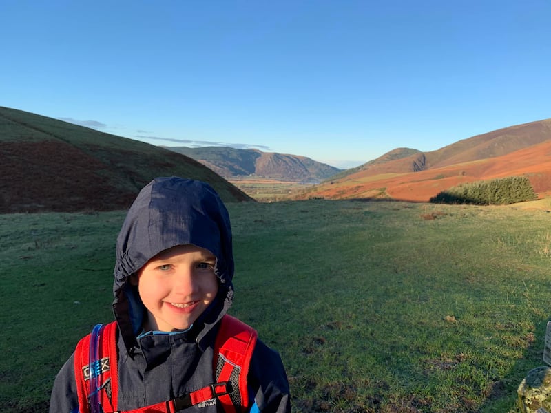 Boy wearing a rain jacket and rucksack