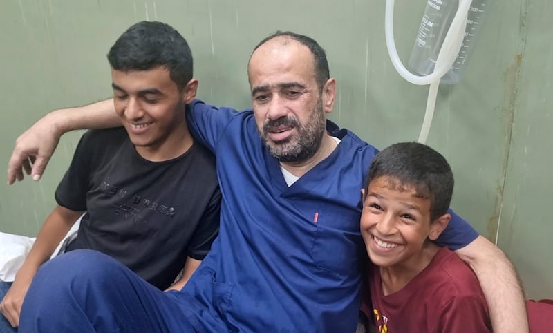 Mohammed Abu Selmia, the director of Gaza’s main hospital, who was detained by Israeli forces in November, sitting with family members after his release on Monday (Mohammad Jahjouh/AP)