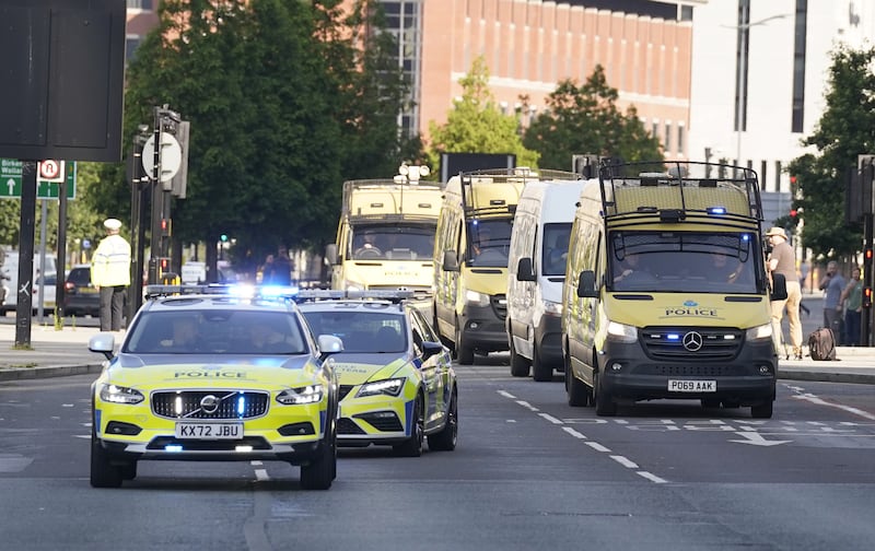 A prison van escorted by multiple police vehicles arrives at Liverpool Magistrates’ Court