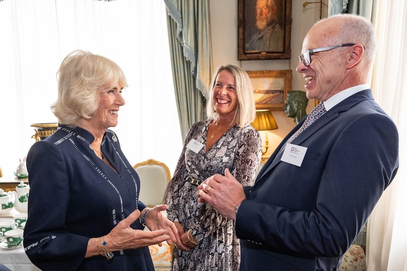 Camilla shares a joke with some of her guests during the osteoporosis reception. Aaron Chown/PA