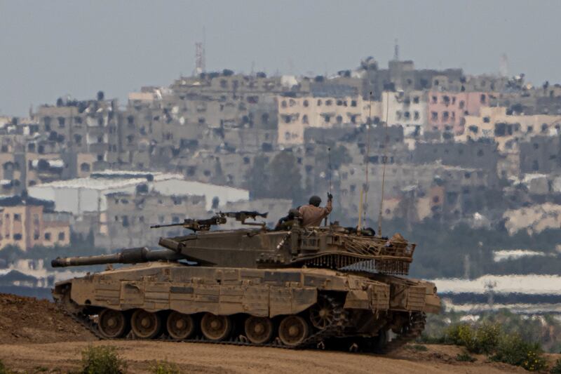 An Israeli soldier on top a tank on the border with the Gaza Strip in southern Israel on March 17 (Ariel Schalit/AP)