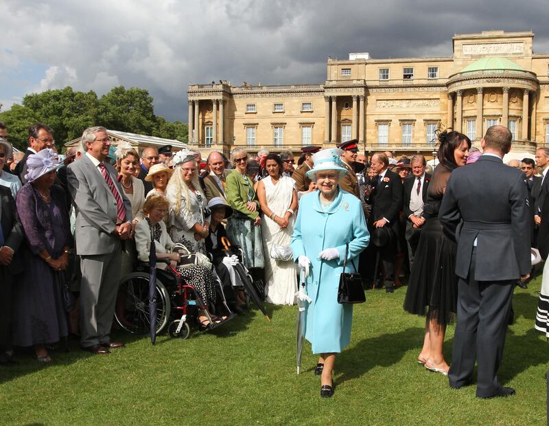 The Queen walks among guests during a Buckingham Palace Garden Party