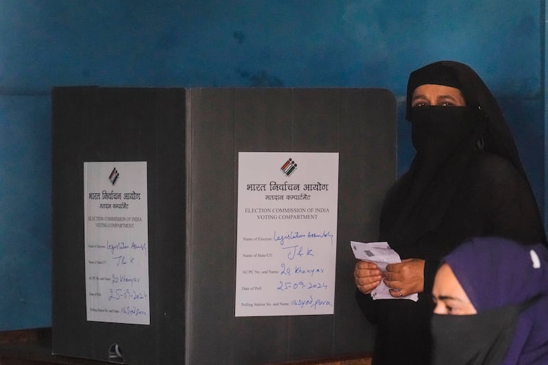 A woman casts her vote in Srinagar, Indian controlled Kashmir (Mukhtar Khan/AP)