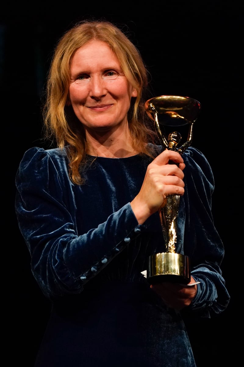 Samantha Harvey poses with the trophy. (AP Photo/Alberto Pezzali)