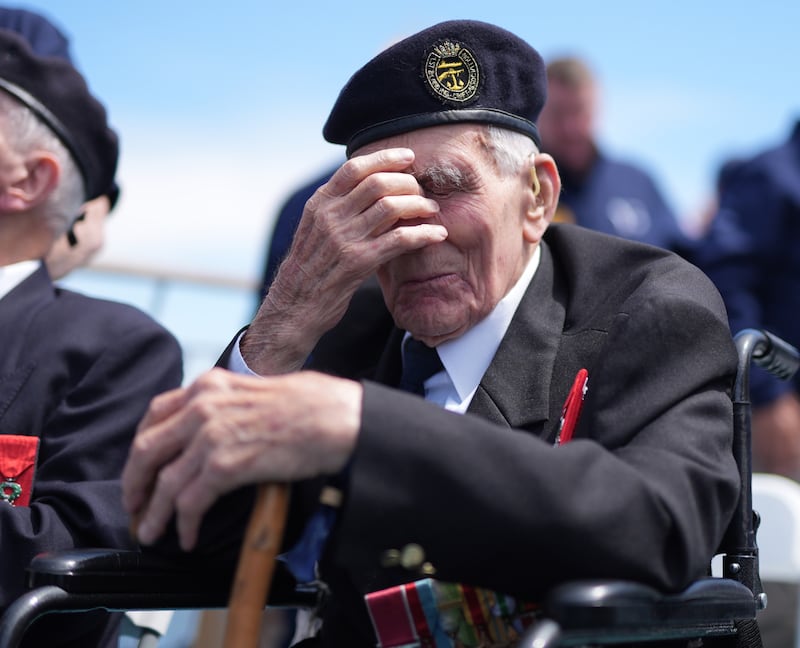 D-Day veteran John Dennett, 99, from Liverpool, covers his eyes during a wreath-laying service just off the French coastline