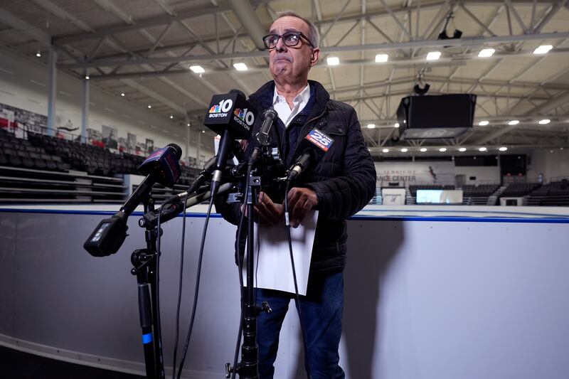 Doug Zeghibe, of the Skating Club of Boston, pauses while announcing that six athletes, coaches and family are believed to have perished in the air crash (Charles Krupa/AP)