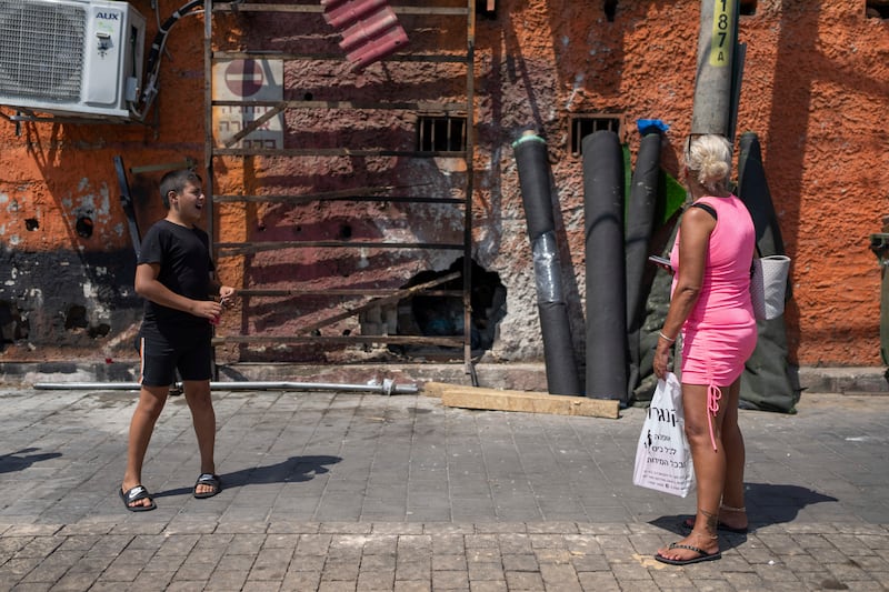 People look at the damage after a bomb explosion in Tel Aviv, Israel (Ohad Zwigenberg/AP)