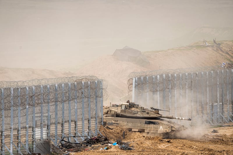Israeli soldiers drive a tank across the border with the Gaza Strip (Ariel Schalit/AP)