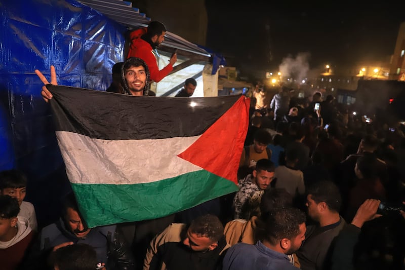 Palestinians celebrate the announcement of a ceasefire deal (Mariam Dagga/AP)