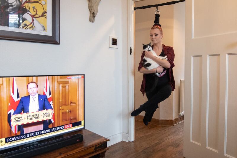 Circus performer Anastasia Sawicka practises her ‘hair hanging’ skills at her home in Northampton 