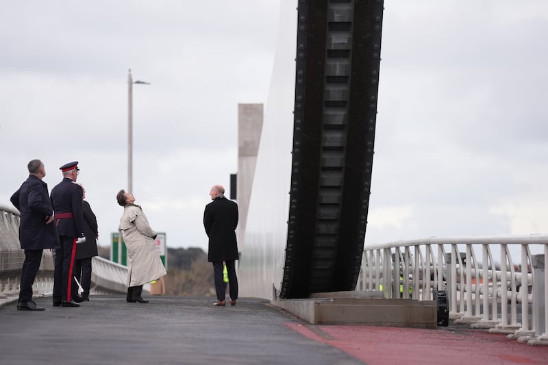 Anne peers up at the gull wings of the bridge