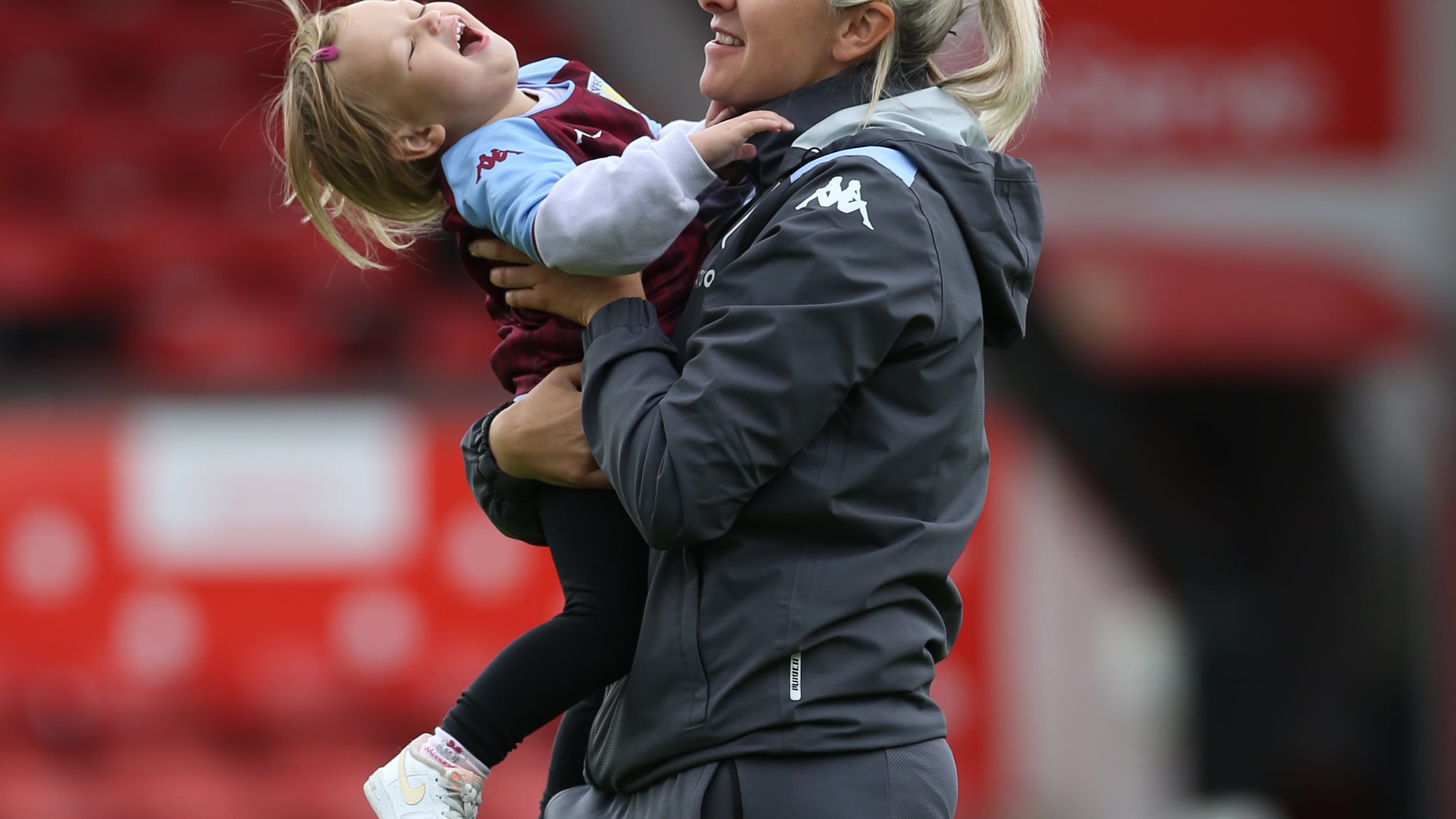 Aston Villa manager Carla Ward with her daughter on the pitch