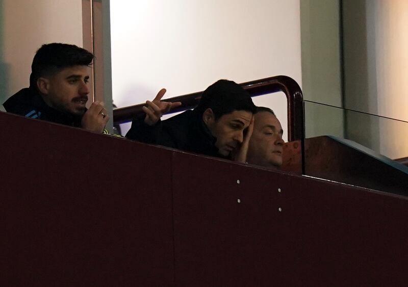 Arteta (centre) watched Arsenal’s defeat at Villa Park from the stands