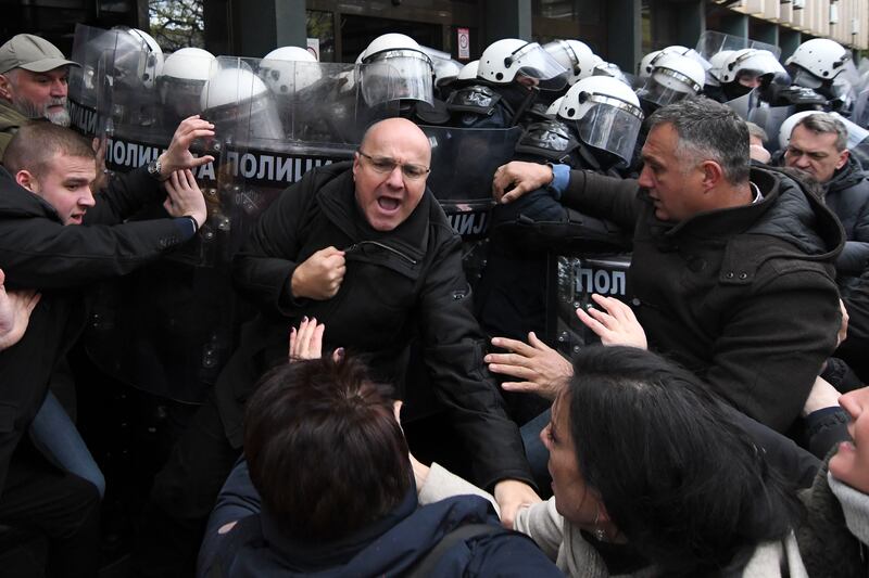 Serbian police officers scuffled with opposition protesters demanding arrests over the deadly roof collapse (AP)