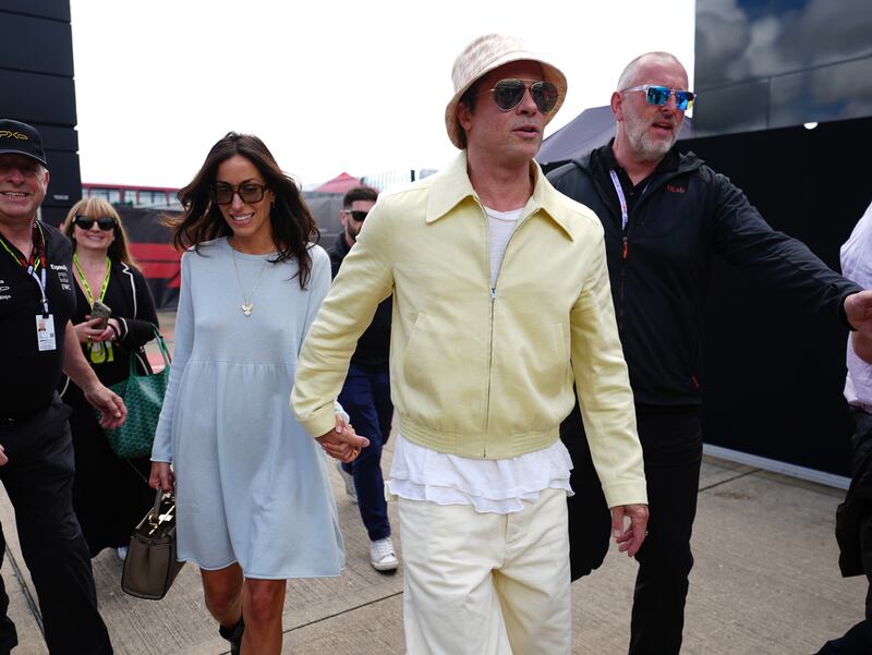 Brad Pitt and Ines de Ramon arrive in complimenting primary colours at Silverstone