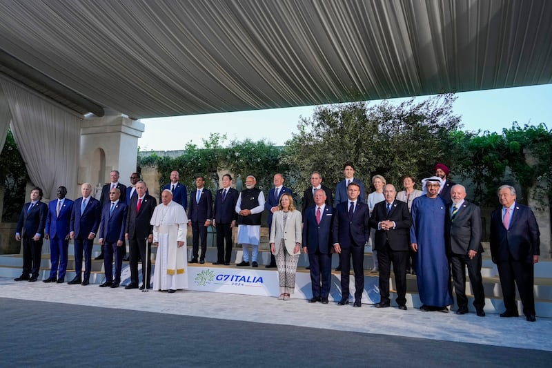 G7 leaders and invitees pose for a group photo in Borgo Egnazia, near Bari in southern Italy at the end of the two-day summit (Andrew Medichini/AP)