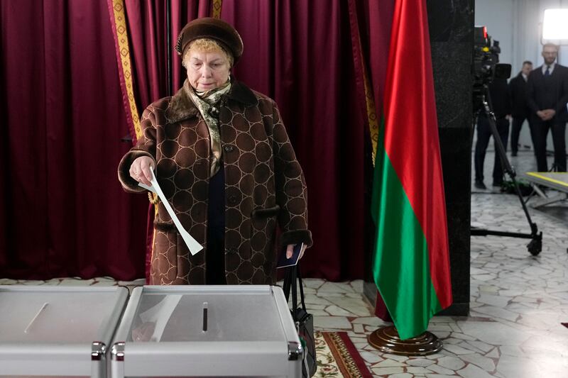 A woman casts her ballot at a polling site (Pavel Bednyakov/AP)