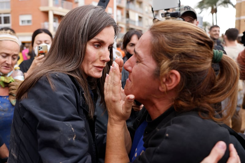 Spain’s Queen Letizia, left, comforts a woman affected by the floods in Paiporta, near Valencia, (Ana Escobar/EFE/AP)