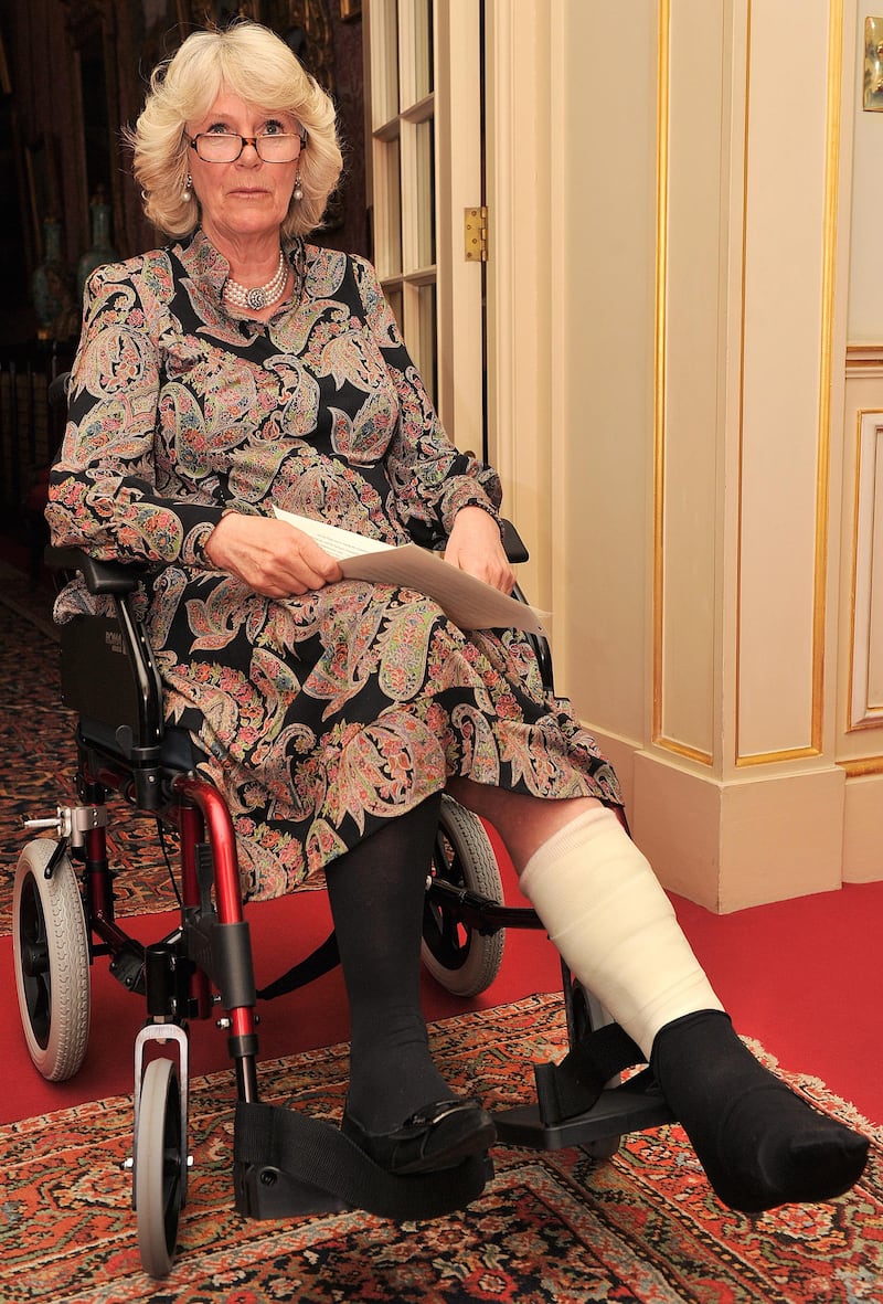 The then Duchess of Cornwall with a cast and in a wheelchair on her first official appearance in 2010 after breaking her leg