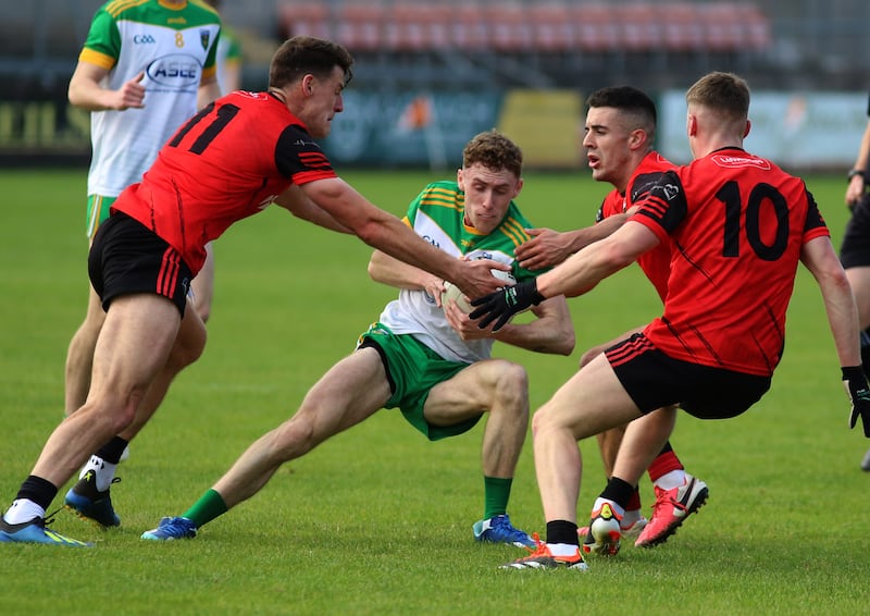 Mullaghbawn's Pauric Mackin comes under pressure from Madden men including Niall Grimley and Joe Sheridan.