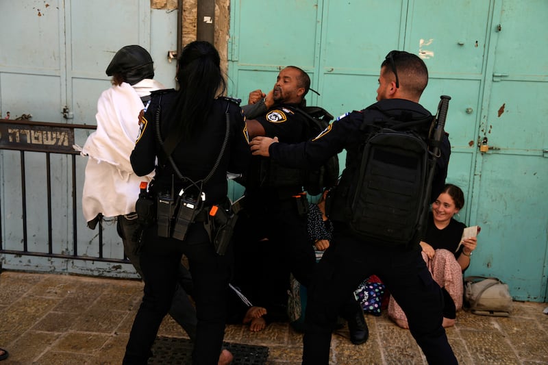 Israeli police prevent a Jewish worshipper from breaking through the police barrier to enter Jerusalem’s most sensitive holy site (Ohad Zwigenberg/AP)