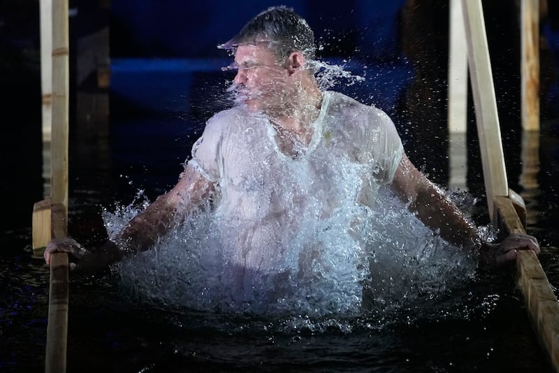 A man shakes off water while plunging himself into icy waters in Moscow, Russia (Pavel Bednyakov/AP)