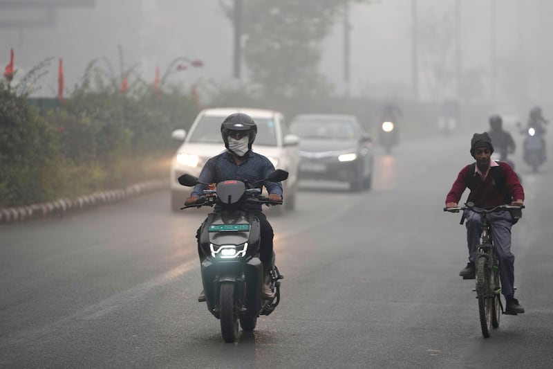 Commuters drive through the smog (Manish Swarup/AP)