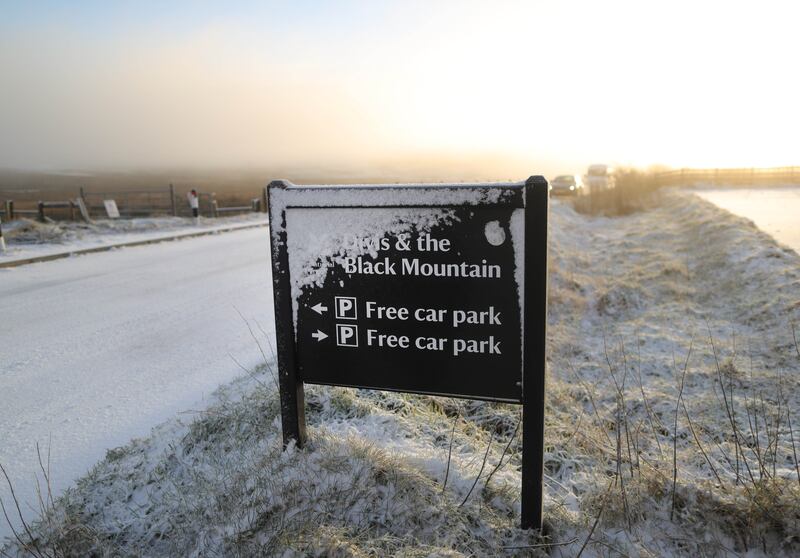 Walkers  on Divis mountain on Monday, as Snow showers, ice, fog, frosty nights and low daytime temperatures are all forecast in the coming days.
PICTURE: COLM LENAGHAN