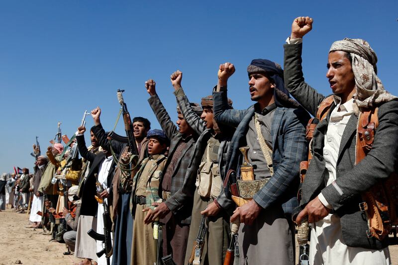 Houthi fighters and tribesmen stage a rally against the US and the UK strikes on Houthi-run military sites near Sanaa (AP)