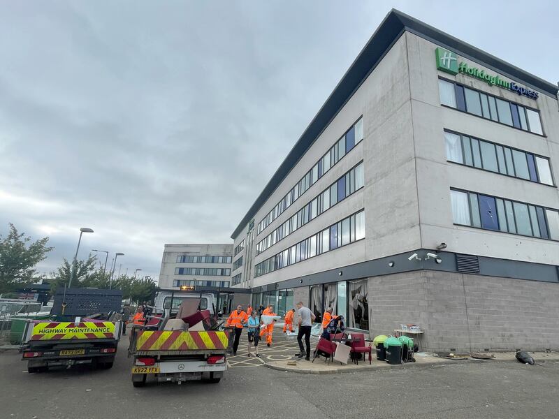 People helped to clear debris at the Holiday Inn Express on Monday