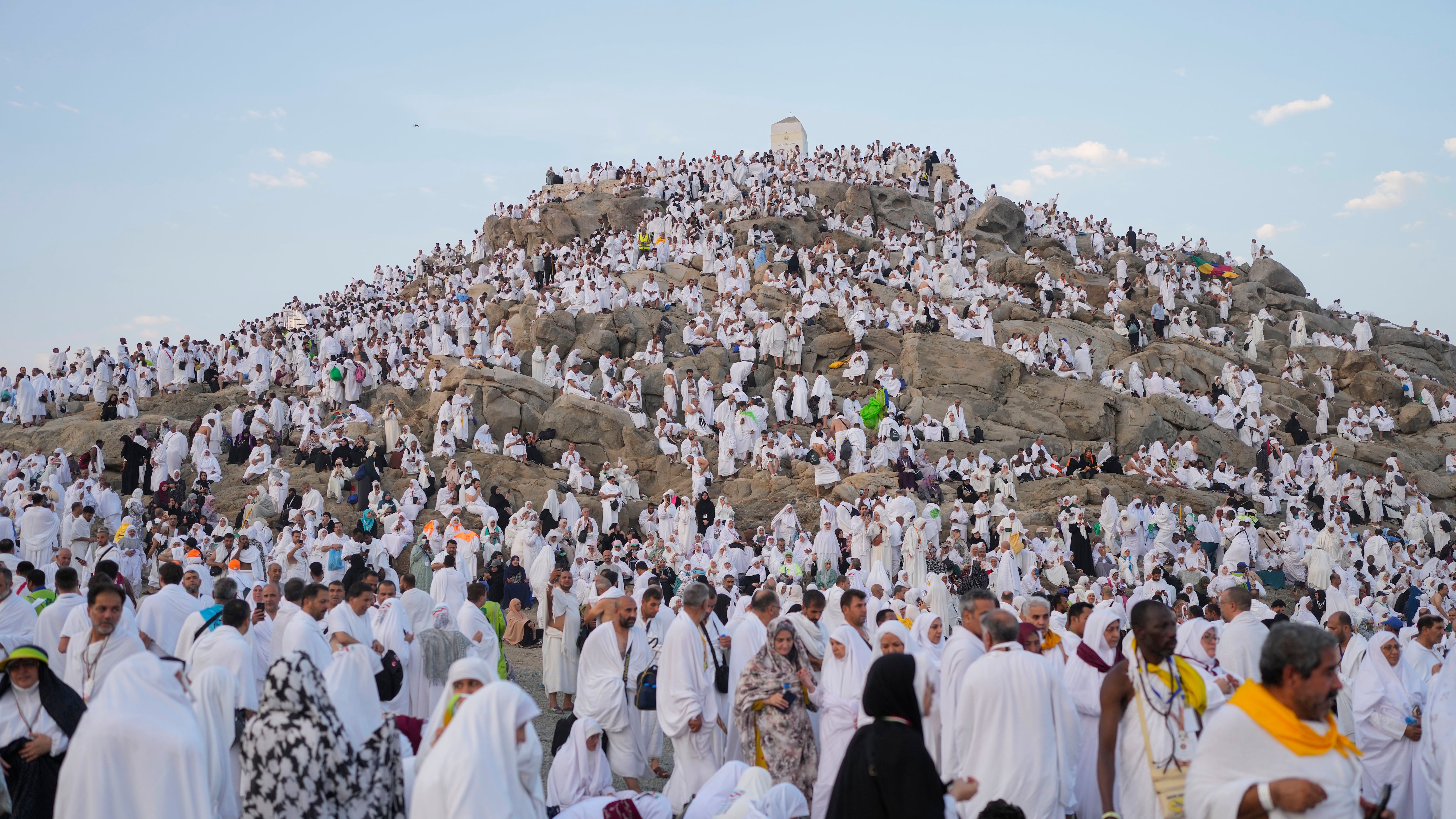 Muslim pilgrims gather at the top of the rocky hill known as the Mountain of Mercy (Rafiq Maqbool/AP)