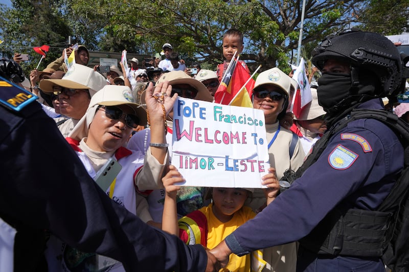 A child holds a welcome sign for Pope Francis in Dili, East Timor (Firdia Lisnawati/AP)