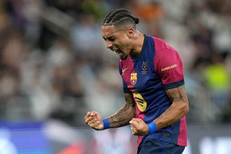 Raphinha scored twice and set up another goal as Barcelona beat Real Madrid 5-2 in the Spanish Super Cup final in Saudi Arabia (Altaf Qadri/AP)