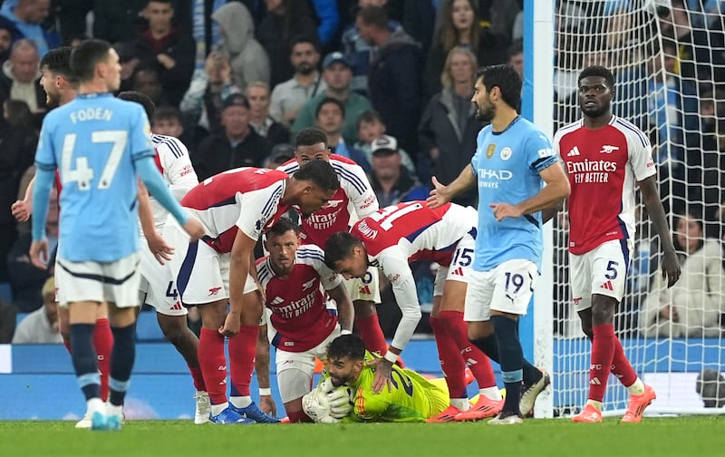 Arsenal celebrate a save by goalkeeper David Raya against Manchester City