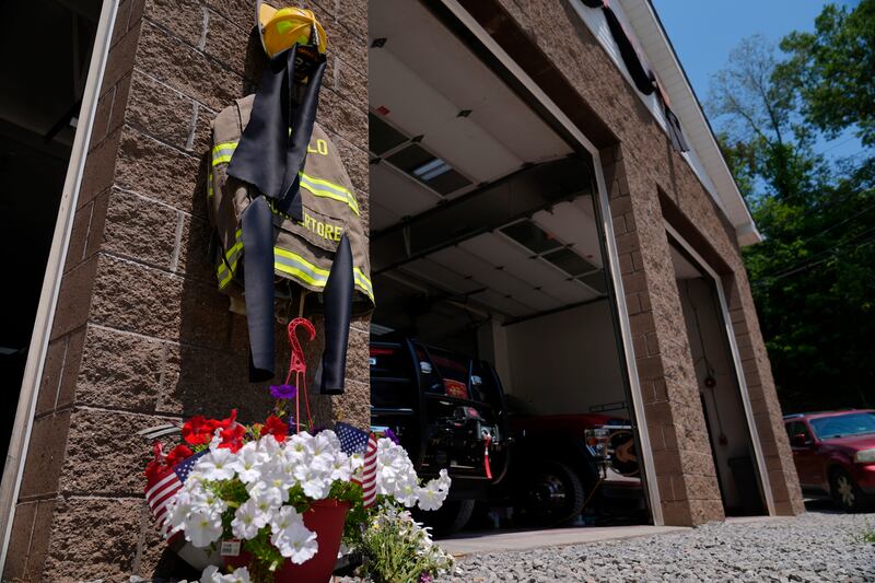 Flowers and a tribute to fallen firefighter Corey Comperatore are pictured at the Buffalo Township Volunteer Fire Company (Sue Ogrocki/AP)