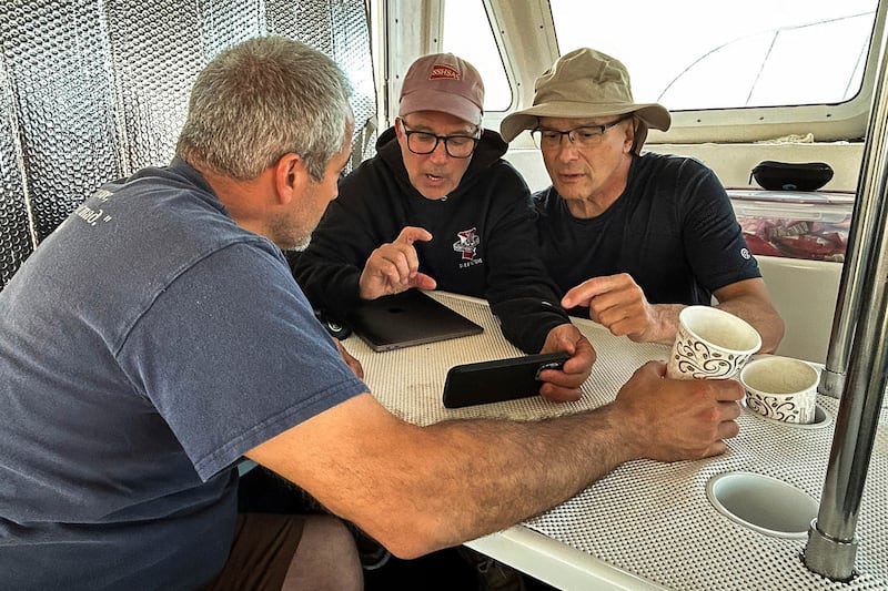 Team members review footage between dives (Atlantic Wreck Salvage, via AP)