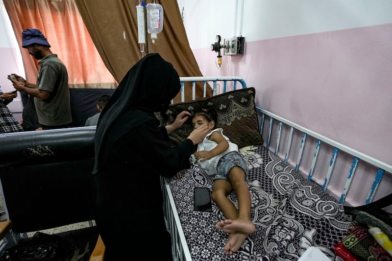 A Palestinian child waits to receive a polio vaccination at a hospital in Khan Younis (Abdel Kareem Hana/AP)