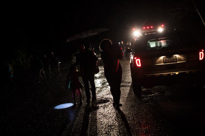 Tofino residents and visitors leave the community center after the tsunami warning ends, in Tofino, British Columbia