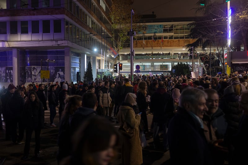 Protesters gather outside Serbia’s state television building in Belgrade on Thursday (AP/Marko Drobnjakovic)