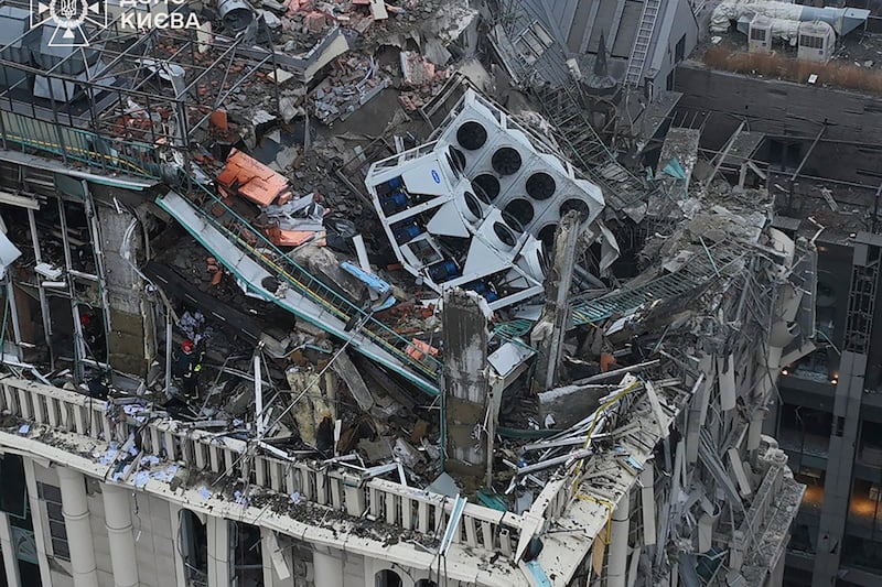 Firefighters work on the site of a damaged building after a Russian missile attack in Kyiv (Ukrainian Emergency Service via AP)