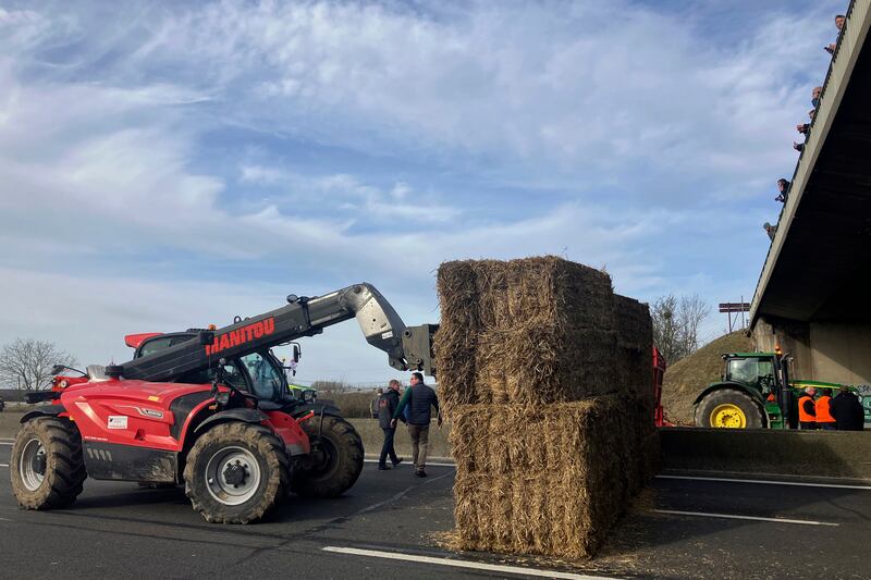 Farmers block a motorway near Jossigny, east of Paris with hay bales (Sylvie Corbet/AP)