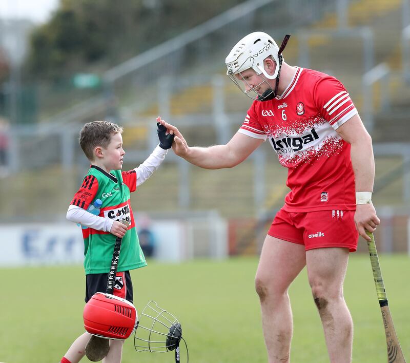 A young hurler meets Richie Mullan of Derry on the pitch after beating London during the NHL match played at Celtic Park, Derry on Sunday 25th February 2024. Picture Margaret McLaughlin