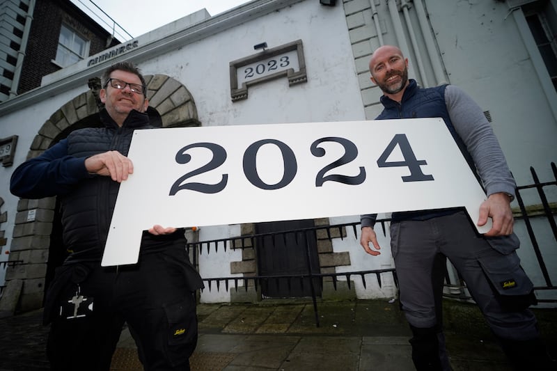 (L-R) Carpenters Robbie Minto and Eoghan Kelly with the new Guinness Date sign for St James Gate.