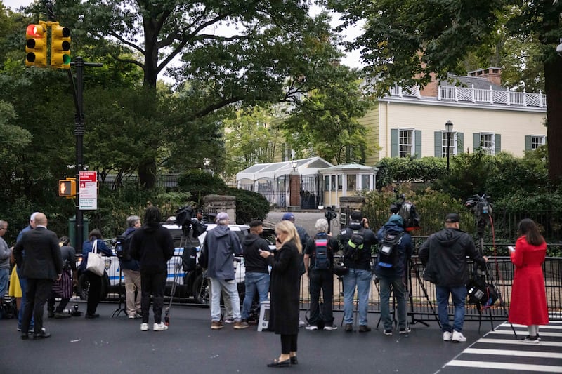 Members of the media gather outside Gracie Mansion, the official residence of New York City mayor Eric Adams (Yuki Iwamura/AP)