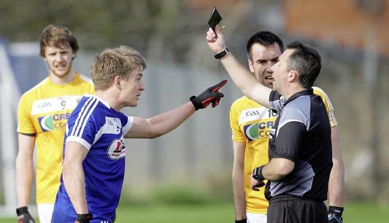 Laois&#39;s David Conway and Antrim&#39;s Kevin Niblock both argue about their simultaneous black cards from referee Eamon O&#39;Grady - but the official&#39;s task is extremely difficult. Picture by Cliff Donaldson 