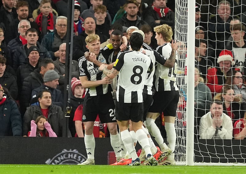 Newcastle’s Alexander Isak is surrounded by team-mates after scoring the winner at Tottenham